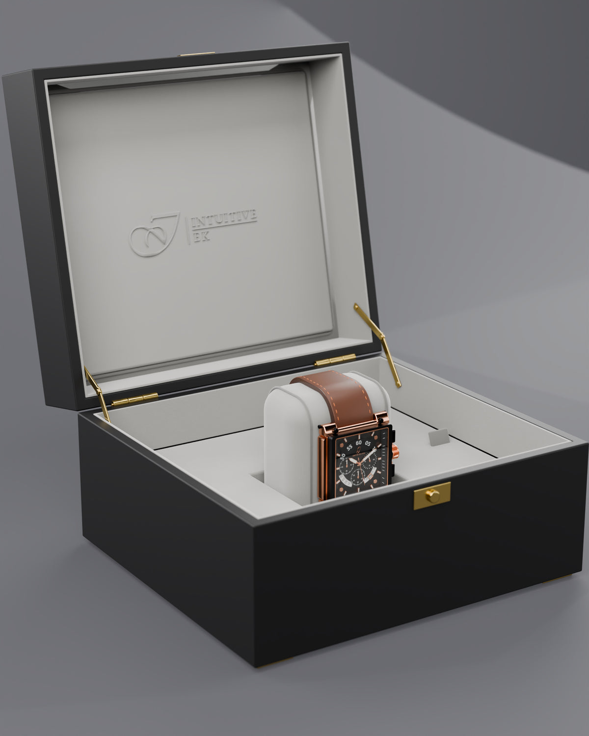 Intuitive EK presentation box open, showing the EK77 watch on its cushion and the gold logo inside the lid